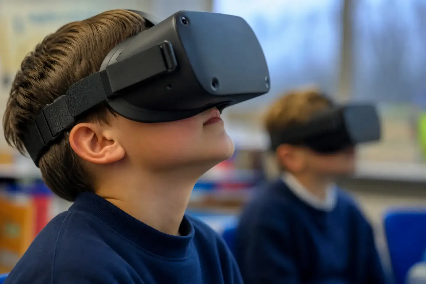 Two VR headsets and their controllers laid out on a covered table beside a pack of cleaning wipes and a charging cable, close in and softly lit.