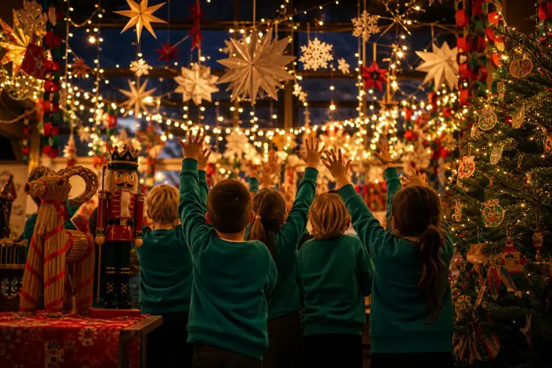 Warm string lights, pine branches, handmade paper stars and winter cards on a wooden classroom table.
